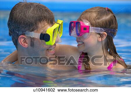 Stock Image - Portrait of father and daughter snorkeling. Fotosearch