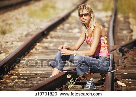 Stock Image - Portrait of Woman on railroad tracks. Fotosearch