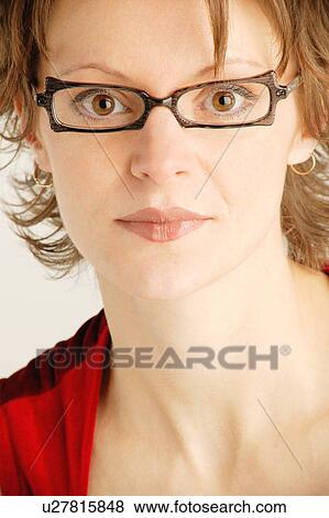 Portrait of woman with black framed glasses View Large Photo Image Stock Photo - Portrait of woman with black framed glasses. Fotosearch