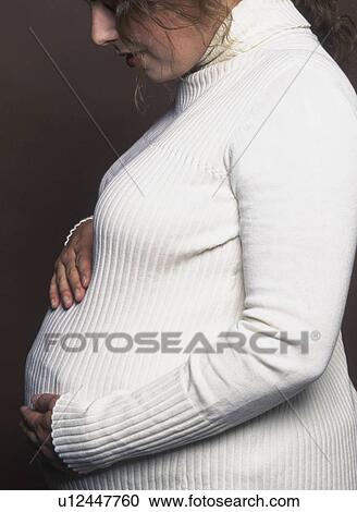 Pregnant woman stroking belly View Large Photo Image Stock Image - Pregnant woman stroking belly. Fotosearch