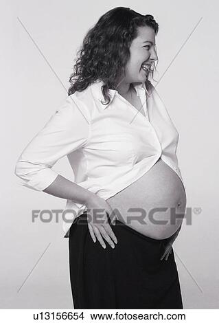 Pregnant woman with belly exposed View Large Photo Image Picture - Pregnant woman with belly exposed. Fotosearch