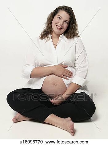 Stock Image - Pregnant woman with belly exposed. Fotosearch