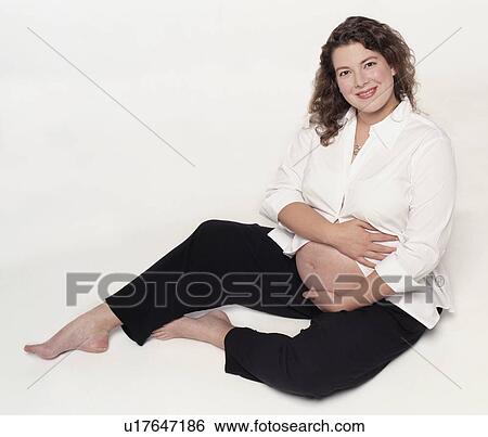 Stock Photograph - Pregnant woman with belly exposed. Fotosearch
