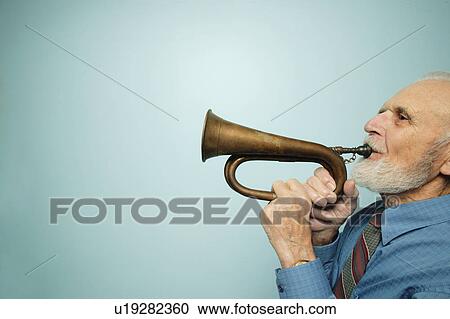 Profile of man playing horn View Large Photo Image Stock Image - Profile of man playing horn. Fotosearch