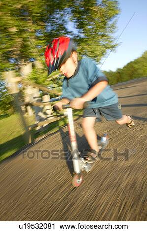 Stock Image - Pushing a scooter. Fotosearch