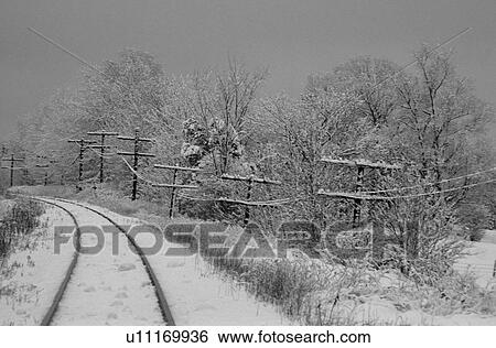 Railroad track with snow all around View Large Photo Image Stock Photograph - Railroad track with snow all around. Fotosearch