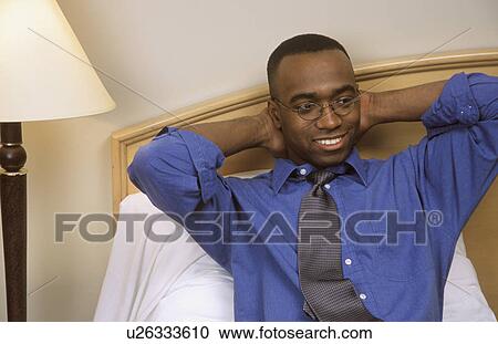 Stock Image - Relaxing in his hotel room. Fotosearch