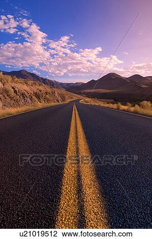Stock Image - Road through mountains. Fotosearch