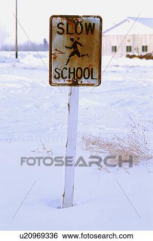 Stock Photograph - Rusty school zone sign in winter. Fotosearch