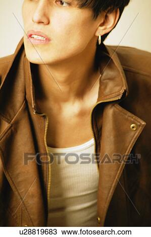 Serious teenager in brown leather jacket View Large Photo Image Stock Image - Serious teenager in brown leather jacket. Fotosearch