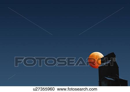 Stock Image - Silhouette of building against dark sky. Fotosearch