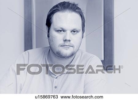 Stock Image - Single man staring into space. Fotosearch