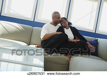 Stock Image - Sitting together under thw window. Fotosearch