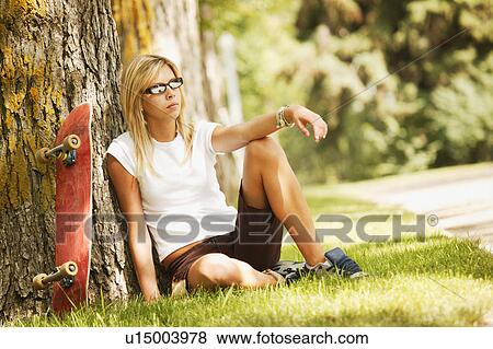 Skateboarder taking a break View Large Photo Image Stock Photo - Skateboarder taking a break. Fotosearch