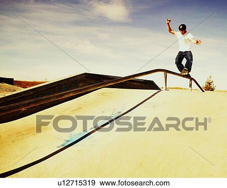 Stock Photo - Skating down a rail. Fotosearch
