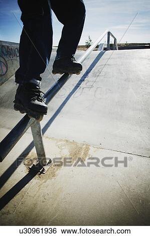 Skating down a rail View Large Photo Image Stock Photograph - Skating down a rail. Fotosearch