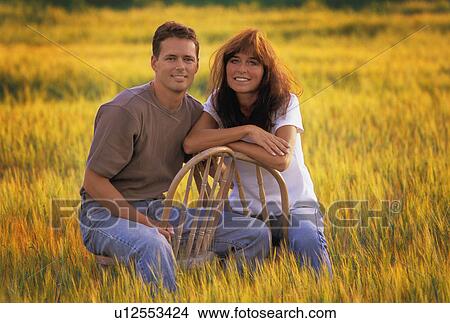 Smiling couple in autumn field View Large Photo Image Picture - Smiling couple in autumn field. Fotosearch