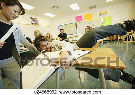 Stock Image - Student falling out of desk. Fotosearch