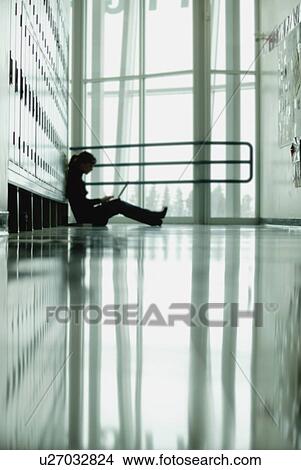 Student sitting by lockers View Large Photo Image Picture - Student sitting by lockers. Fotosearch