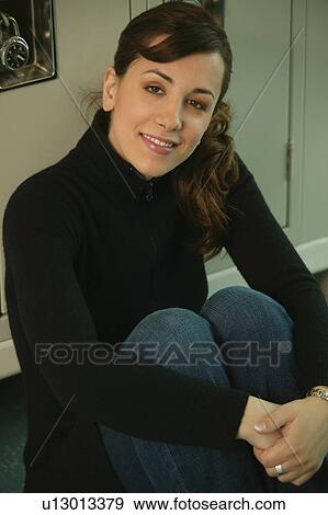 Stock Photo - Student sitting in front of lockers. Fotosearch