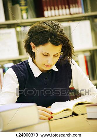 Student studying in library View Large Photo Image Stock Image - Student studying in library. Fotosearch