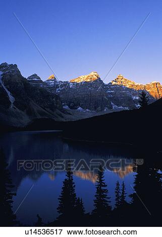 Stock Photo - Sun setting mountain. Fotosearch