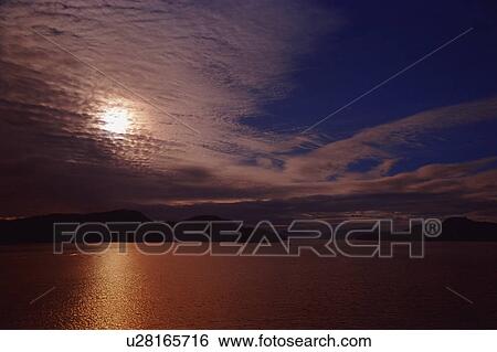 Stock Photograph - Sunlight through clouds. Fotosearch