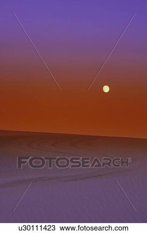 Stock Image - Sunset in a desert. Fotosearch