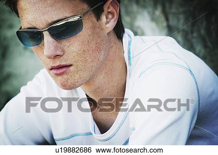 Stock Photograph - Teenage boy with shades. Fotosearch