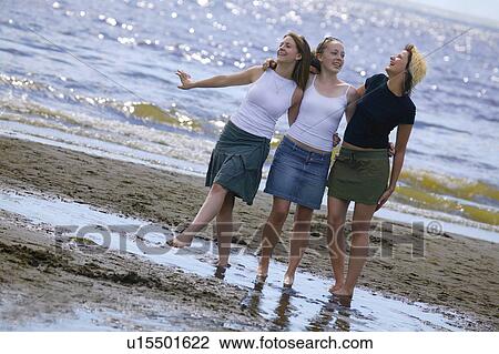 Stock Image - Teenage girls on beach. Fotosearch