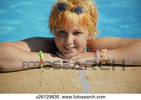 Stock Image - Teenager in a swimming pool. Fotosearch