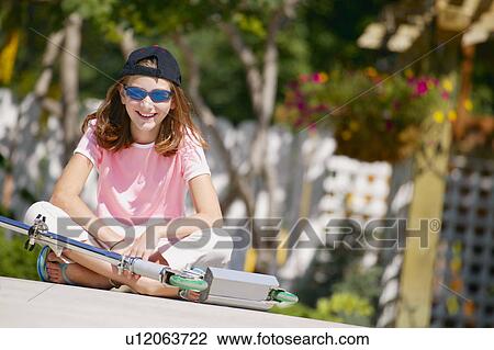 Stock Image - Teenager with a scooter. Fotosearch