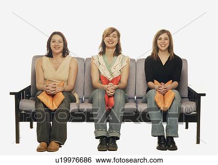 Three women on a sofa View Large Photo Image Stock Photograph - Three women on a sofa. Fotosearch