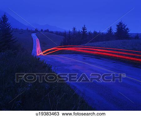 Stock Image - Time delay of small country road in the rain. Fotosearch