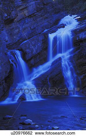Time delay of waterfall over rock cliff View Large Photo Image Stock Image - Time delay of waterfall over rock cliff. Fotosearch