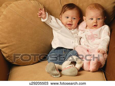 Stock Image - Two babies sitting together. Fotosearch
