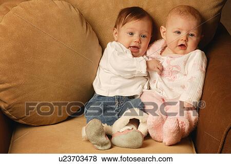 Stock Photo - Two babies sitting together. Fotosearch