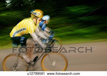 Two cyclists racing on bikes View Large Photo Image Stock Image - Two cyclists racing on bikes. Fotosearch