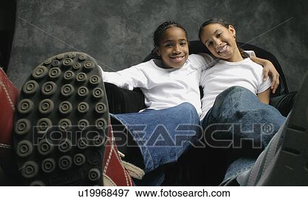 Two girls hanging out View Large Photo Image Stock Photo - Two girls hanging out. Fotosearch