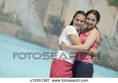 Two girls hug View Large Photo Image Stock Photo - Two girls hug. Fotosearch
