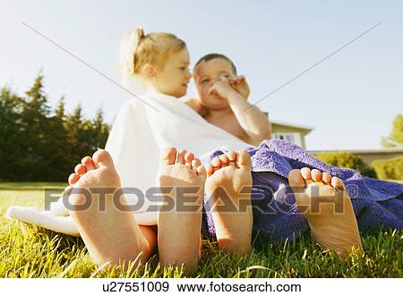 Stock Photo - Two kids dry in a towel. Fotosearch