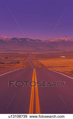 Stock Photo - Two lane highway going down into valley. Fotosearch