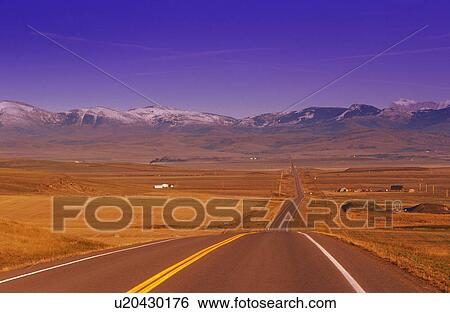 Stock Photograph - Two lane highway to mountains. Fotosearch