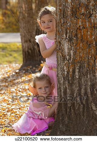 Stock Image - Two little fairy girls in the Autumn forest. Fotosearch