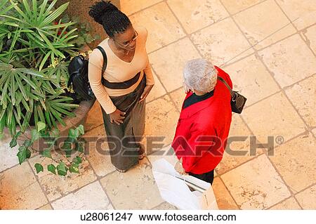 Stock Photo - Two women talking. Fotosearch