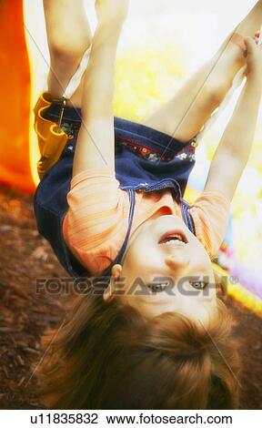 Upside down on a swing View Large Photo Image Stock Image - Upside down on a swing. Fotosearch