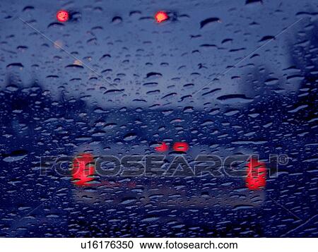 Stock Image - Vehicle lights in rain. Fotosearch