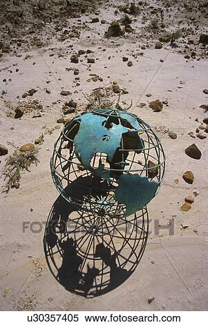 Stock Photography - Wire globe outside on sand. Fotosearch