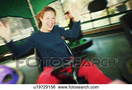 Stock Photograph - Woman at an amusement park. Fotosearch