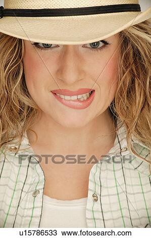 Stock Image - Woman biting lip. Fotosearch
